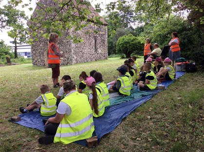 Sunny Bank Primary School children sit outside the church